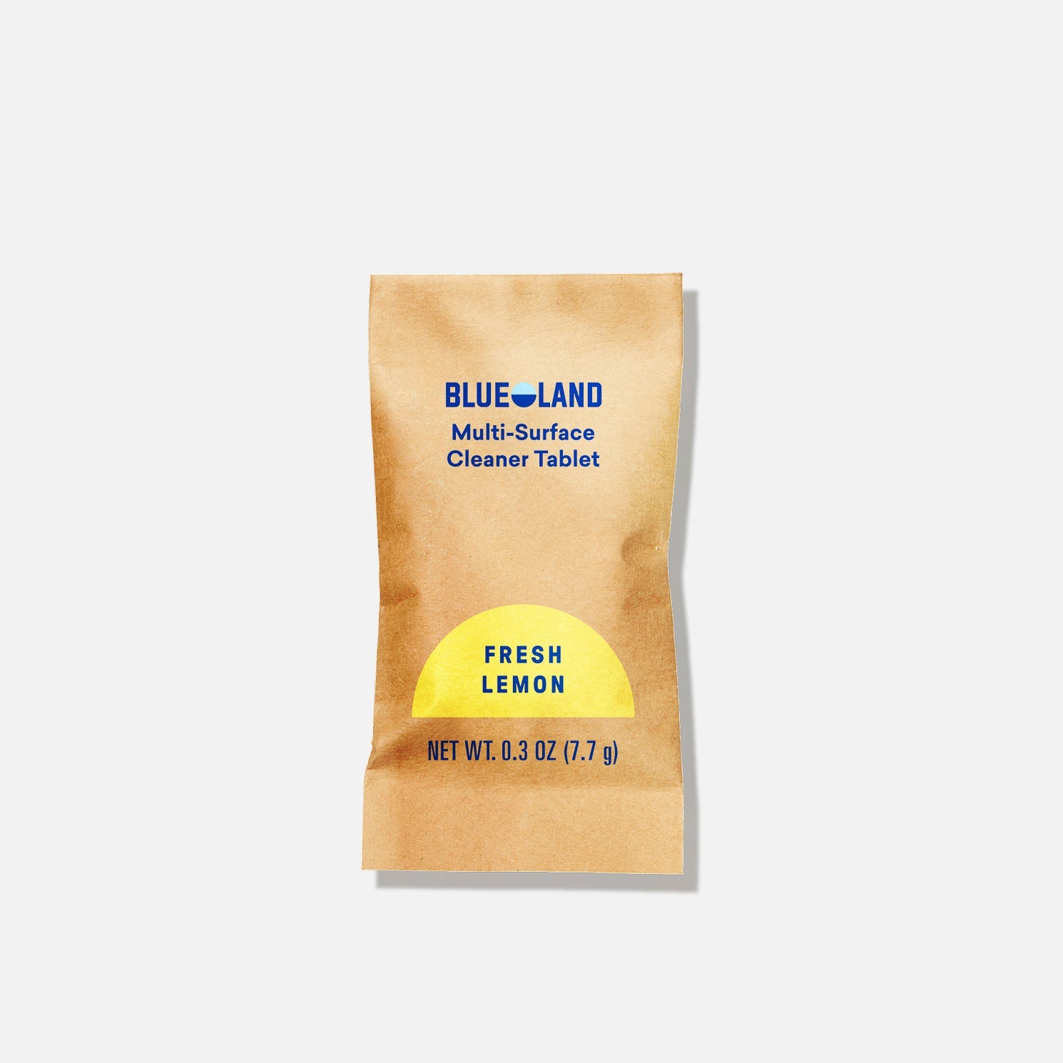 A brown packet labeled BLUE LAND Multi-Surface Cleaner Tablet in blue text and FRESH LEMON in a yellow semicircle. The packet also displays NET WT. 0.3 OZ (7.7 g) on a plain white background.