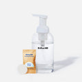 A clear pump bottle labeled Blueland is filled with liquid, next to a small packet labeled Blueland Foaming Hand Soap Free & Clear and a round white soap tablet, all on a white background.