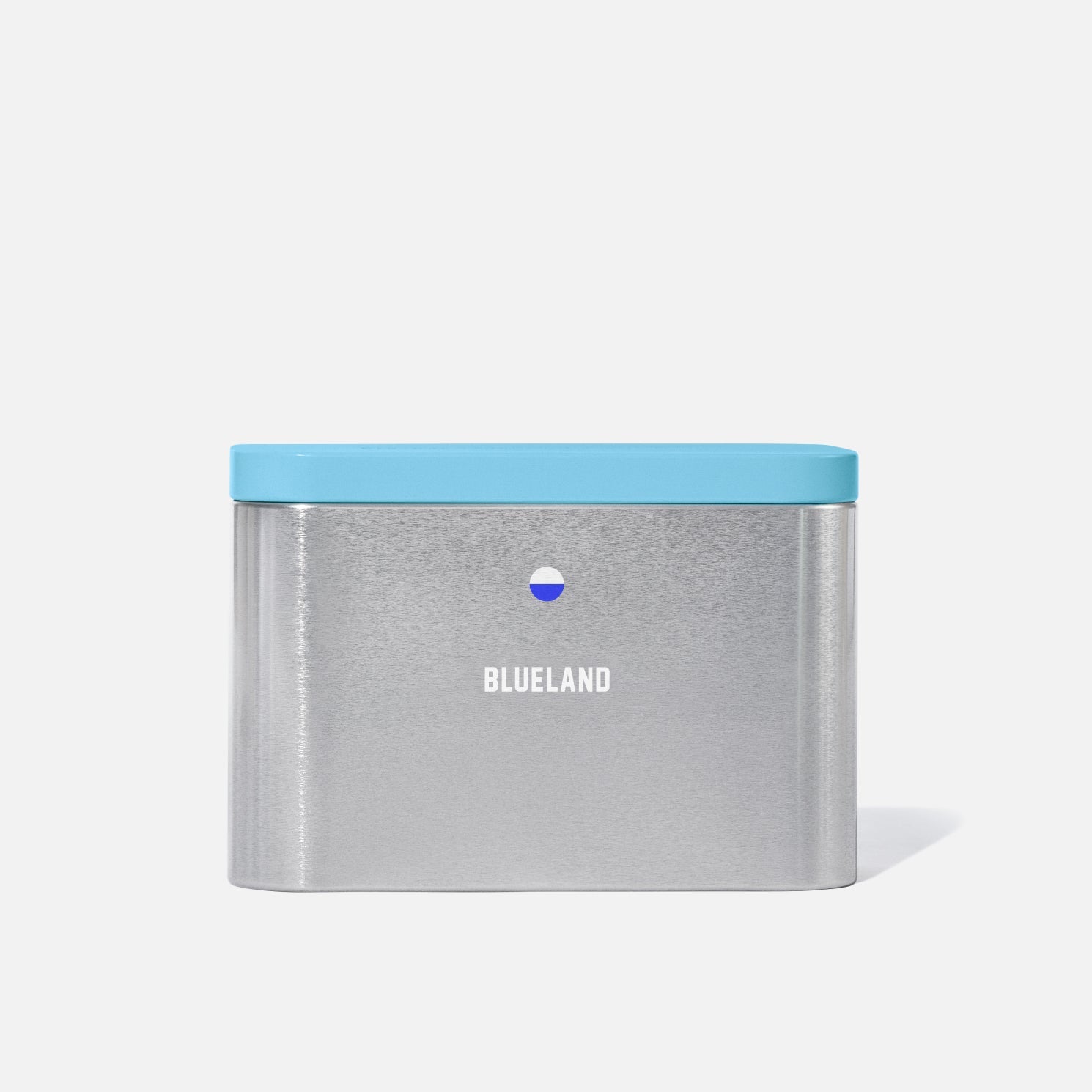 The Forever Tin is a rectangular silver container with a light blue lid and "BLUELAND" printed in white on the front—a stylish, eco-friendly tin designed for plastic-free storage.